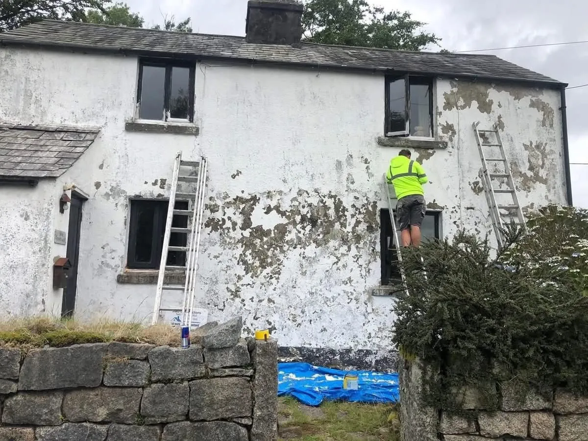 Cottage with blown, flaking render before repair in Ilfracombe